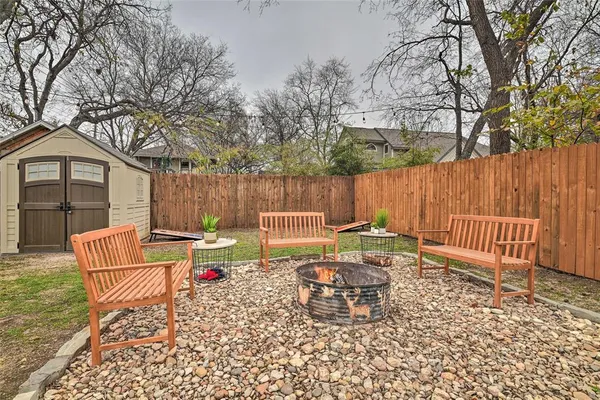 a view of a house with backyard and sitting area