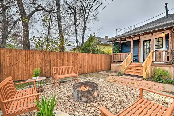 a view of a house with backyard and sitting area