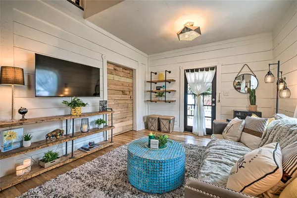 a living room with furniture and a flat screen tv