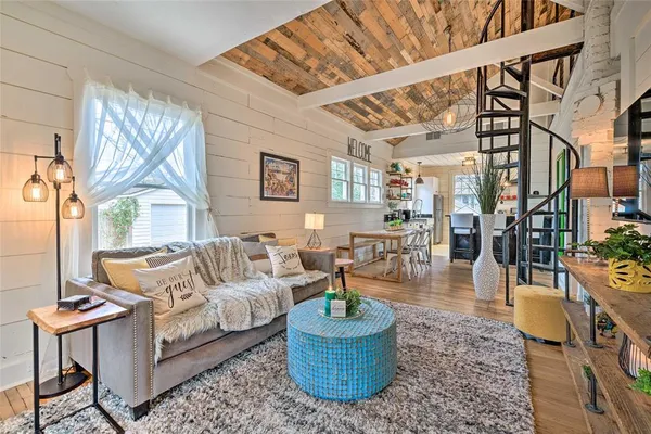 a living room with furniture a fireplace and a large window
