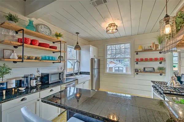 a kitchen with stainless steel appliances granite countertop a sink and cabinets