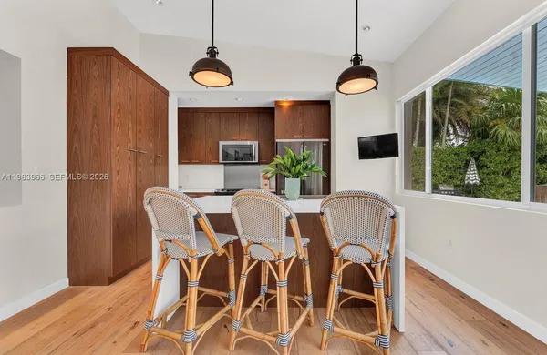 a view of a dining room with furniture window and wooden floor
