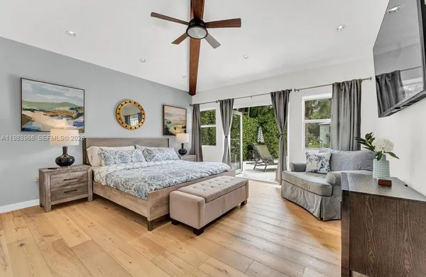 a bedroom with a bed couch and window