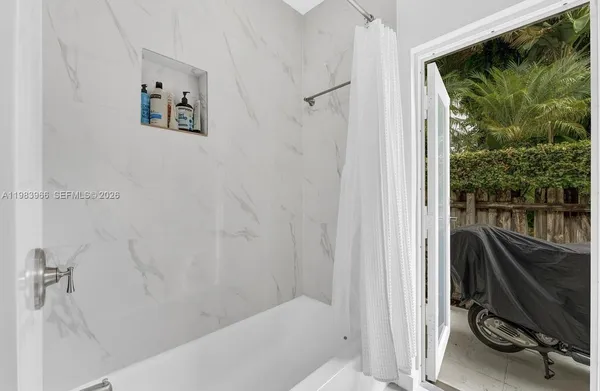 a bathroom with a bathtub and a shower