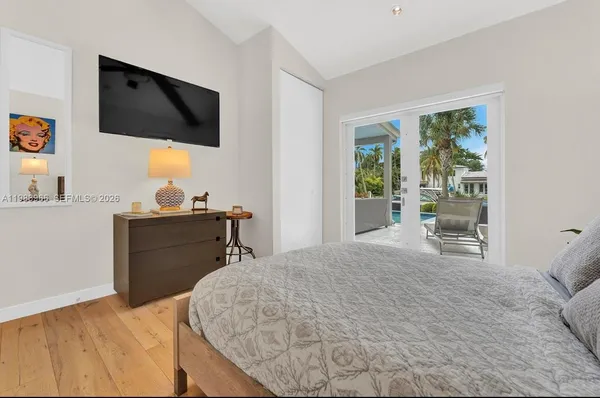 a bedroom with a bed and a flat screen tv