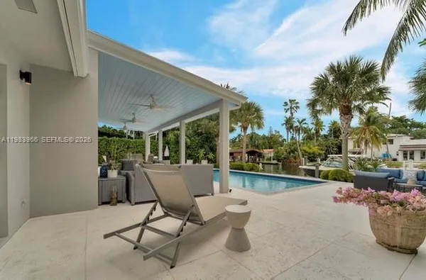 a view of a patio with furniture and garden