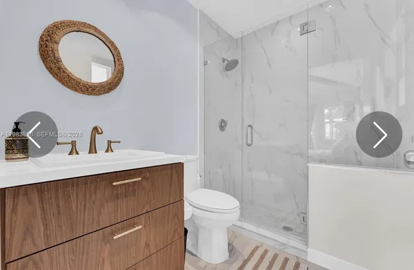 a bathroom with a sink a toilet and a mirror