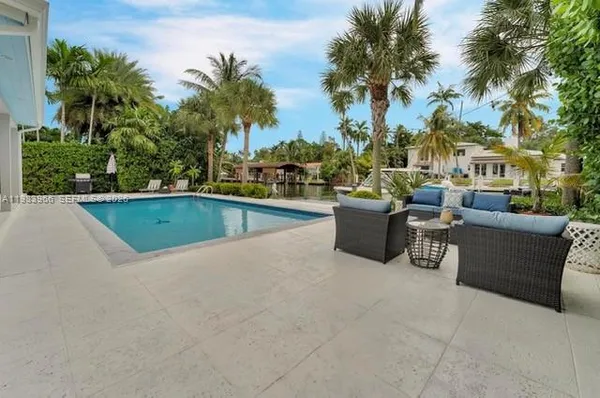 a view of a swimming pool and lounge chair