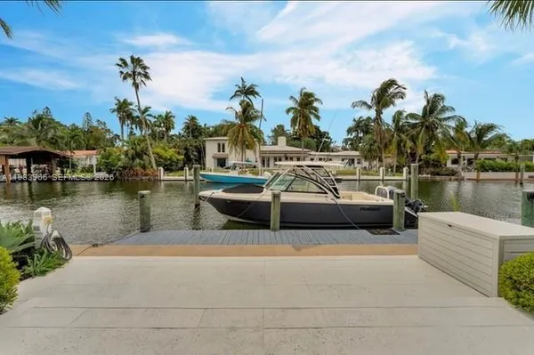 a view of a lake with couches chairs
