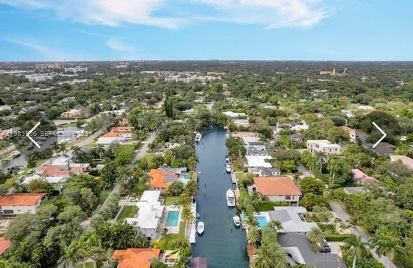 an aerial view of residential houses with city view