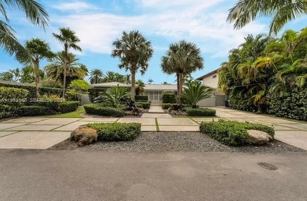a view of a house with a yard and sitting area