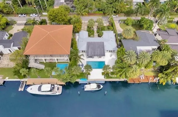 an aerial view of a house with a yard and a fountain