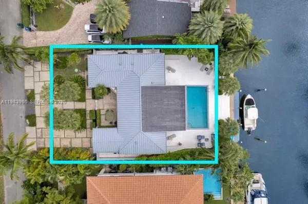 an aerial view of a house with a yard and potted plants