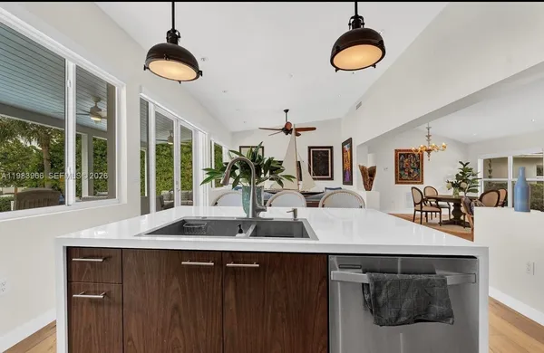 a kitchen with a counter space a sink and a window