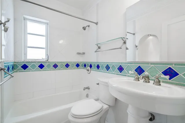 a bathroom with a sink a toilet and a bathtub