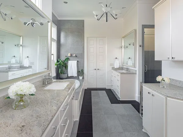a bathroom with a granite countertop sink a toilet and mirror