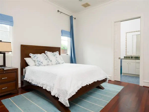 a bedroom with a bed and a view of kitchen