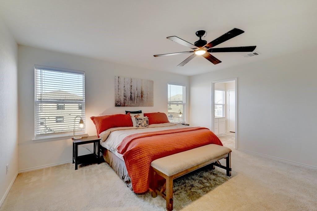 13916 Inaugural Street Manor, TX 78653 - Photo 18 of 28 A naturally illuminated bedroom offers a tranquil retreat with a spacious layout.