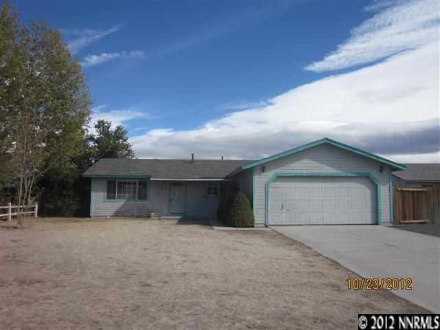 263 River Boat Road Dayton, NV 89403 - Photo 1 of 1 a front view of a house with a yard and garage