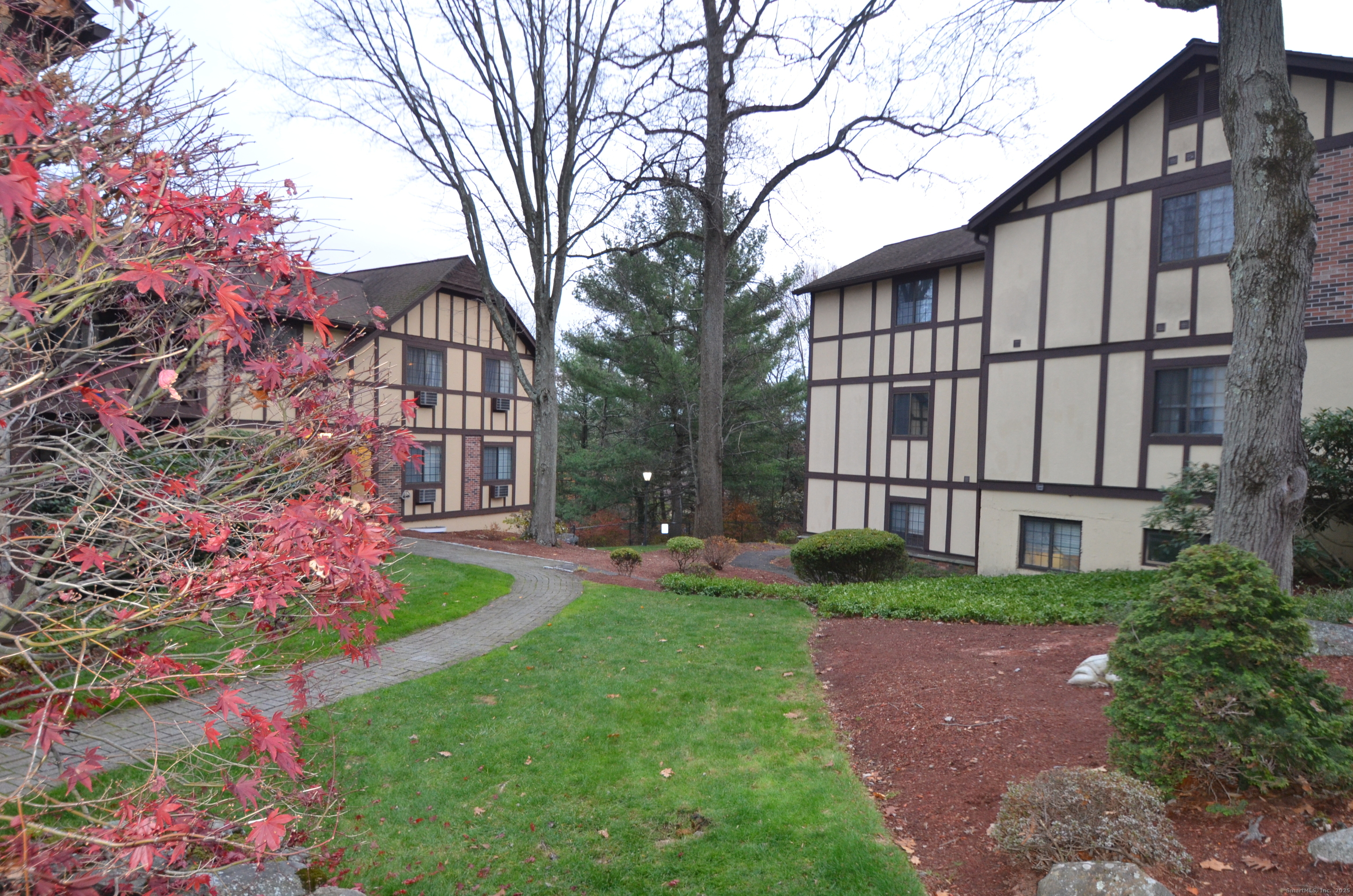 125 Warner Hill Road, Unit 27 Stratford, CT 06614 - Photo 16 of 18 front view of a house with a yard