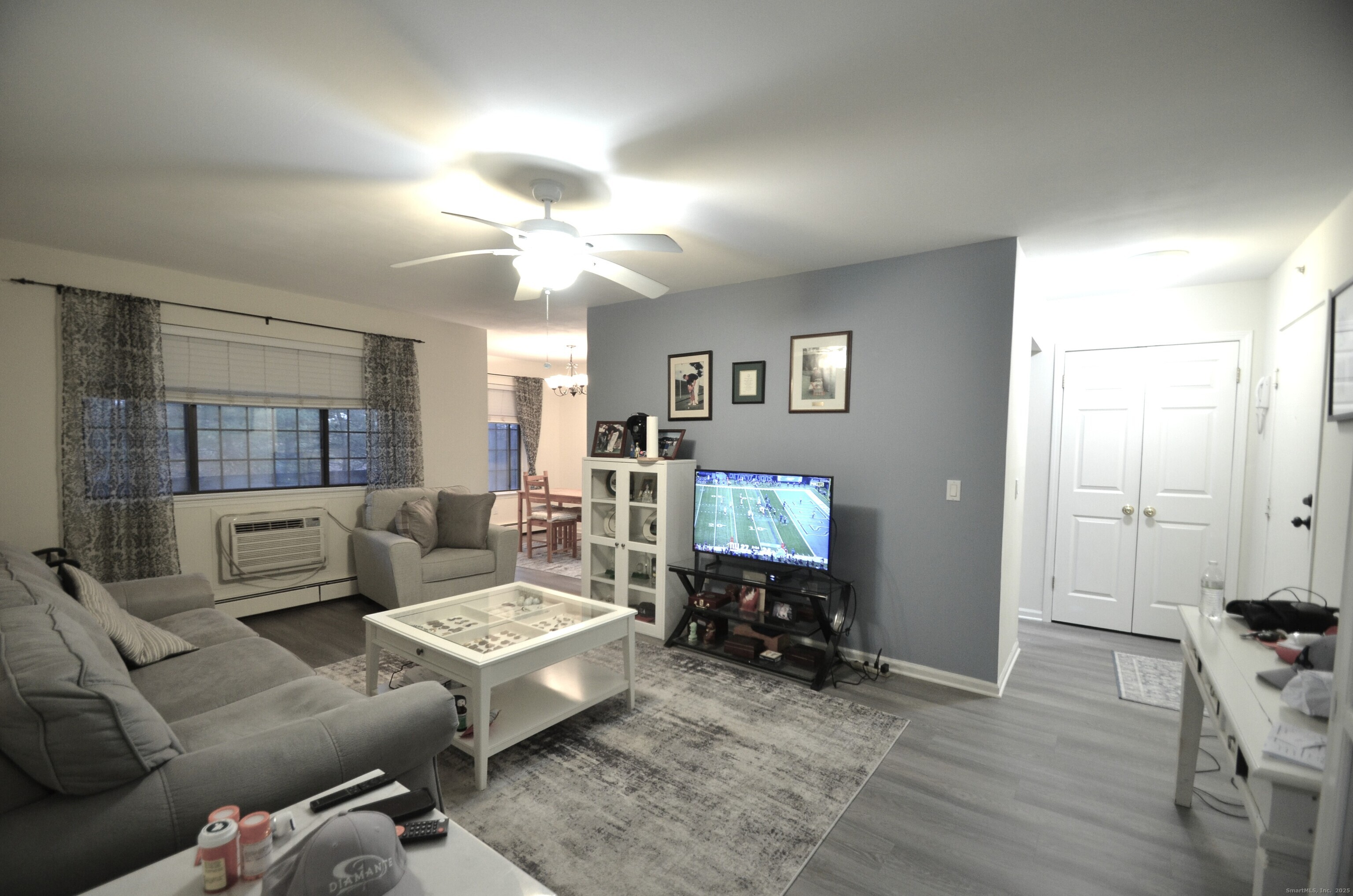 125 Warner Hill Road, Unit 27 Stratford, CT 06614 - Photo 8 of 18 a living room with furniture and a flat screen tv