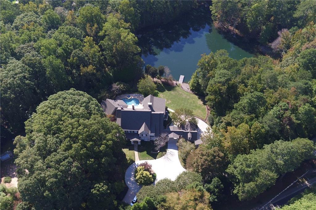 an aerial view of a house with a yard