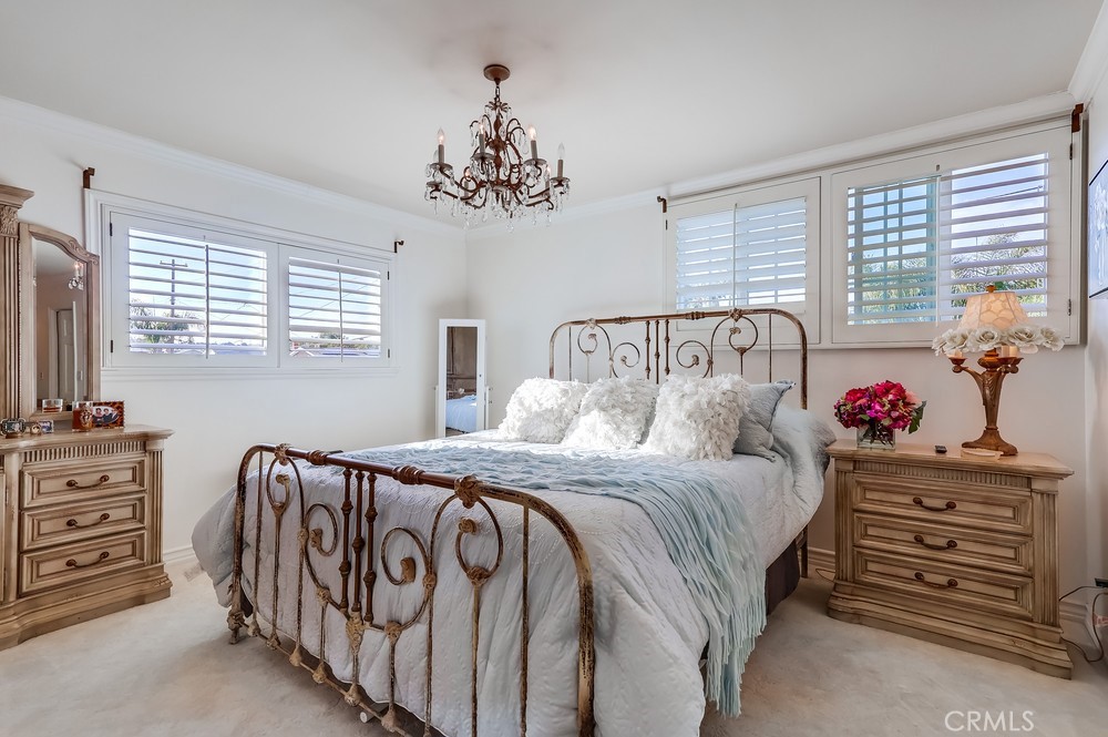 835 Statler Street San Pedro, CA 90731 - Photo 21 of 35 a bedroom with a bed and a chandelier