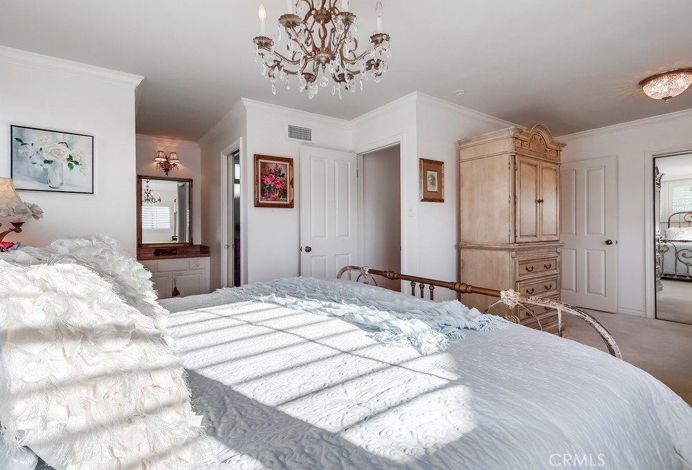 835 Statler Street San Pedro, CA 90731 - Photo 22 of 35 a bedroom with a large bed and a chandelier