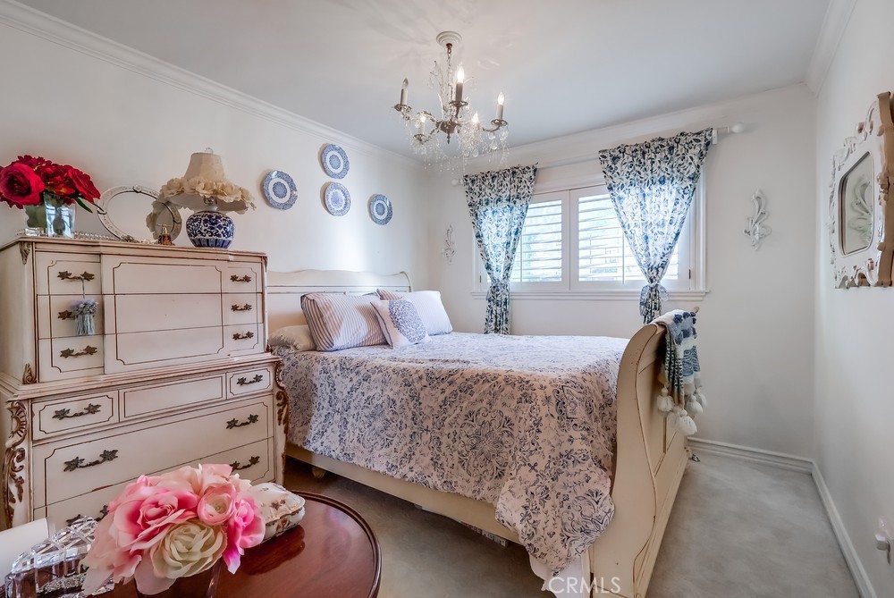 835 Statler Street San Pedro, CA 90731 - Photo 24 of 35 a bedroom with a bed and a chandelier