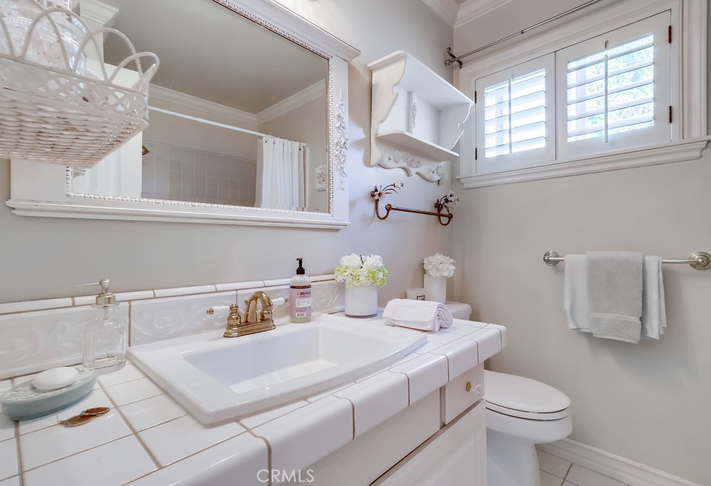 835 Statler Street San Pedro, CA 90731 - Photo 27 of 35 a bathroom with a sink a toilet and a window