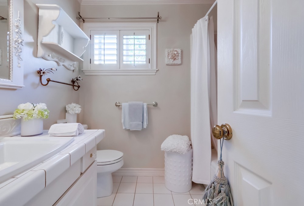 835 Statler Street San Pedro, CA 90731 - Photo 28 of 35 a bathroom with a granite countertop sink a toilet and a mirror