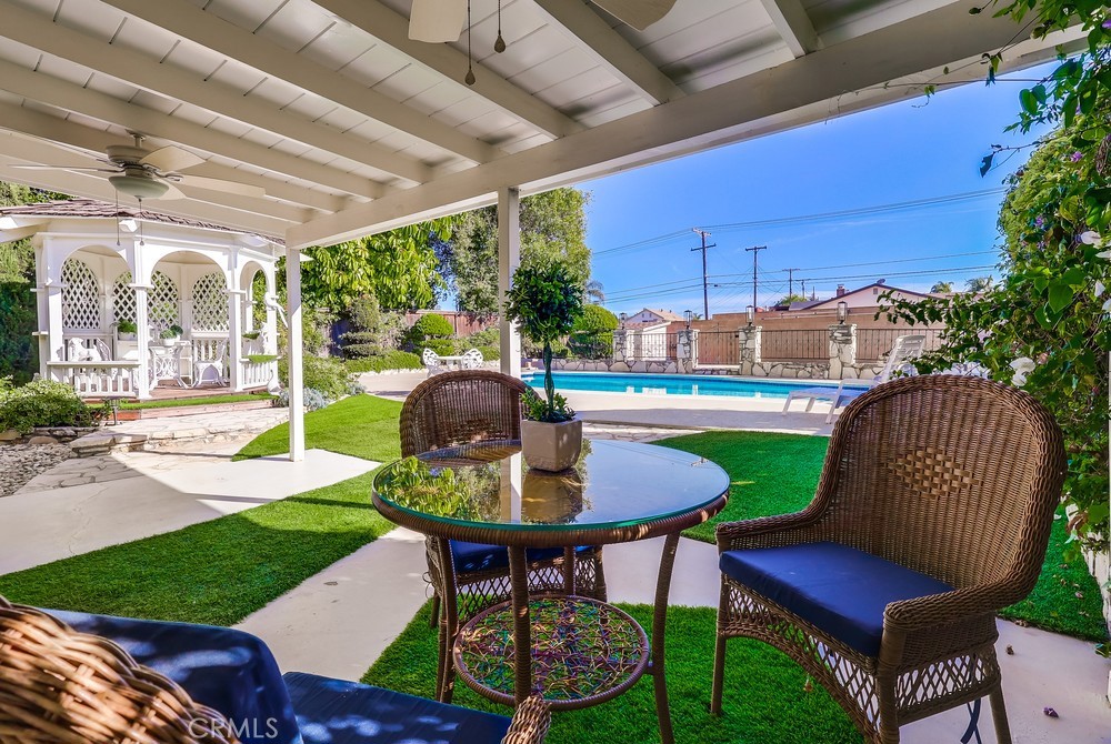 835 Statler Street San Pedro, CA 90731 - Photo 29 of 35 a view of a patio with table and chairs potted plants and a palm tree