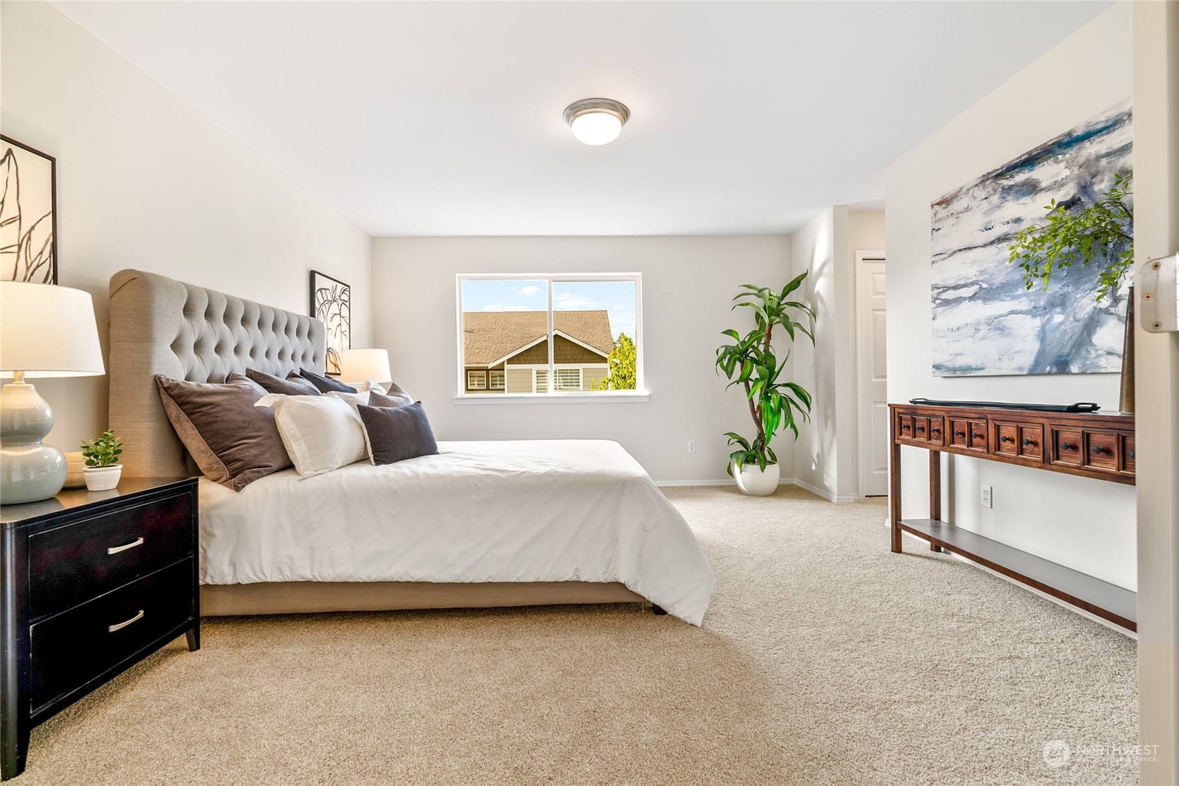 1730 Southeast 30th Place Renton, WA 98055 - Photo 17 of 31 a spacious bedroom with a bed and a painting on the wall
