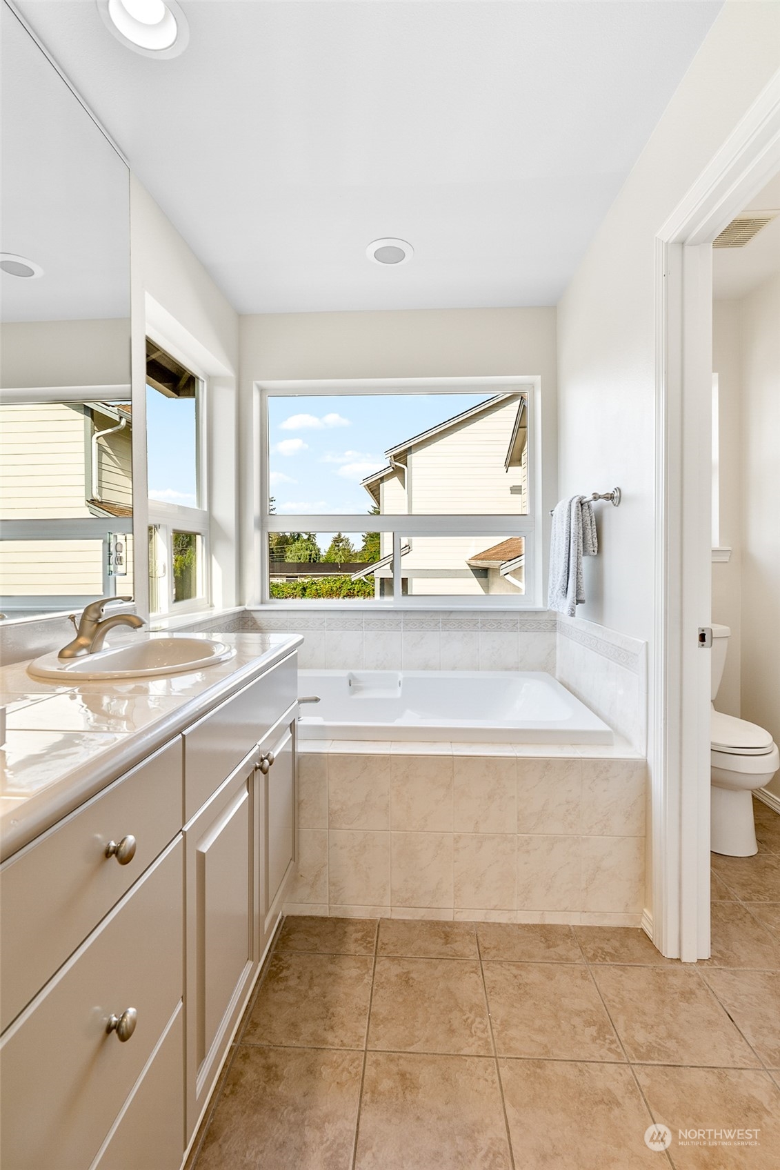 1730 Southeast 30th Place Renton, WA 98055 - Photo 21 of 31 a spacious bathroom with a tub sink and mirror