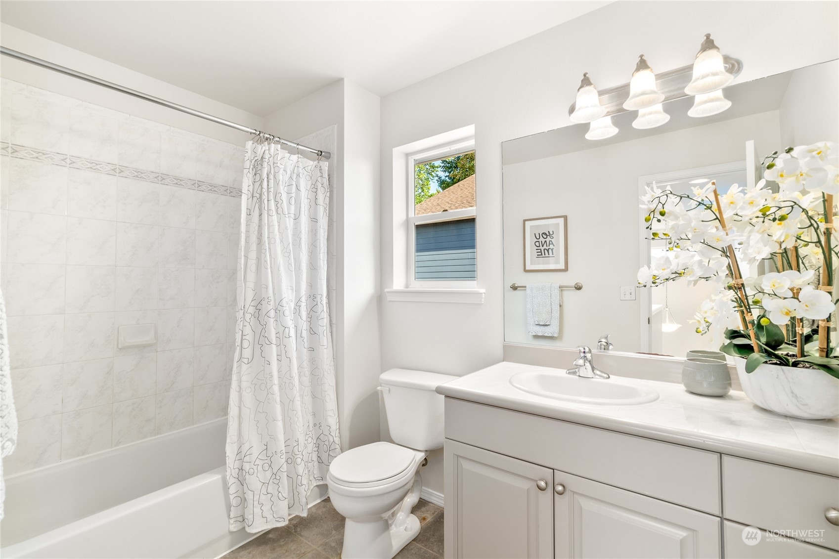 1730 Southeast 30th Place Renton, WA 98055 - Photo 26 of 31 a bathroom with a sink a mirror a bathtub and a toilet