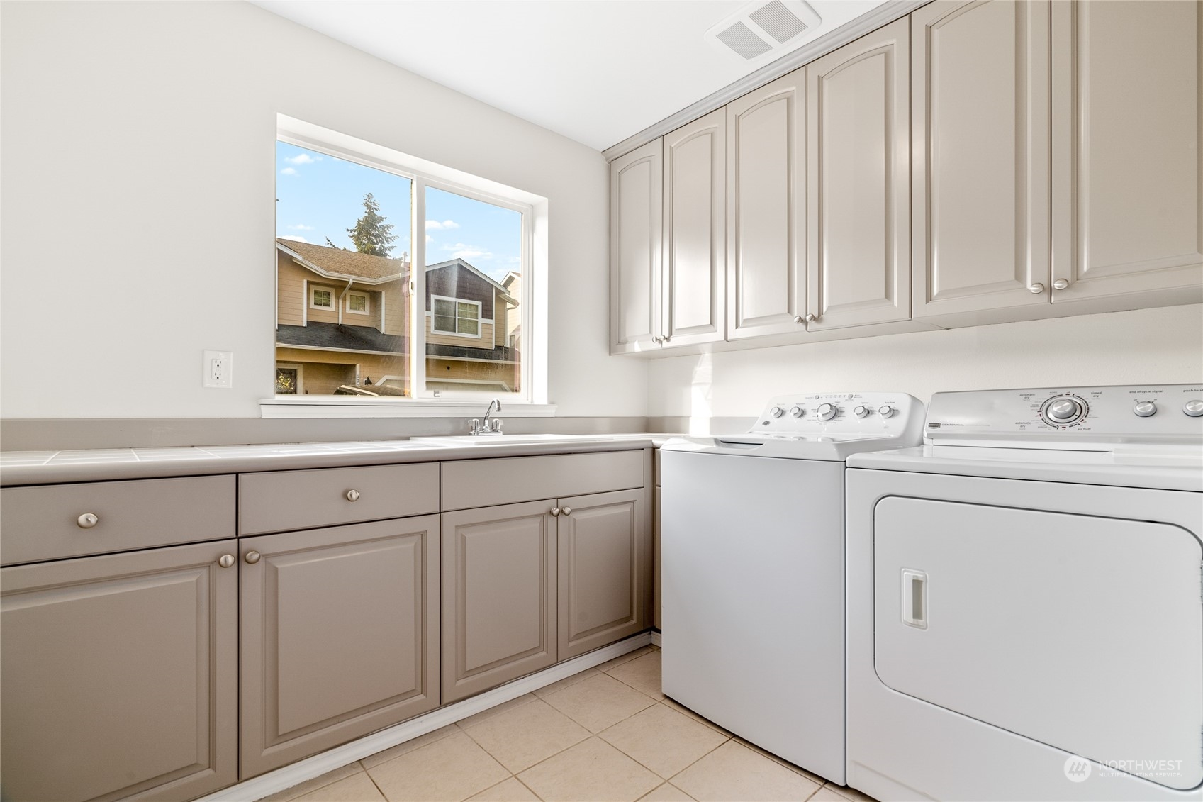 1730 Southeast 30th Place Renton, WA 98055 - Photo 29 of 31 a utility room with cabinets washer and dryer