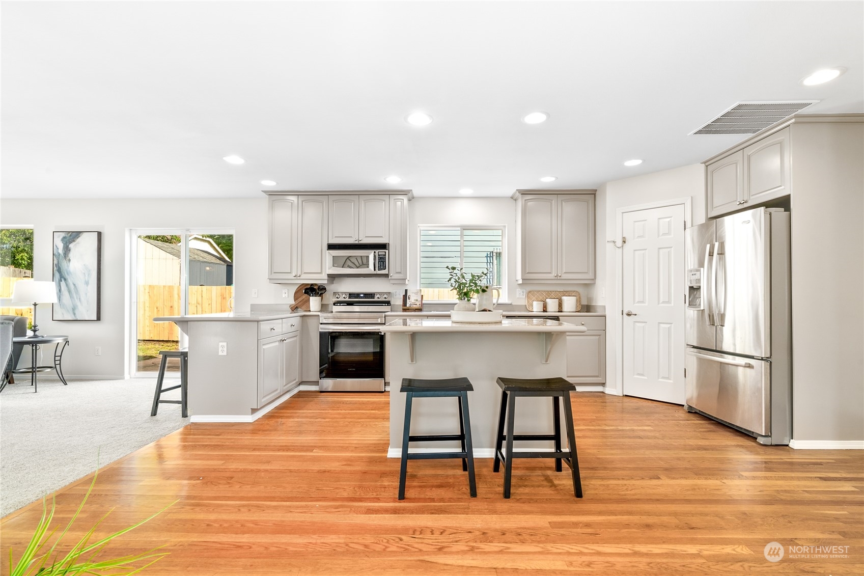 1730 Southeast 30th Place Renton, WA 98055 - Photo 9 of 31 a kitchen with white cabinets and stainless steel appliances