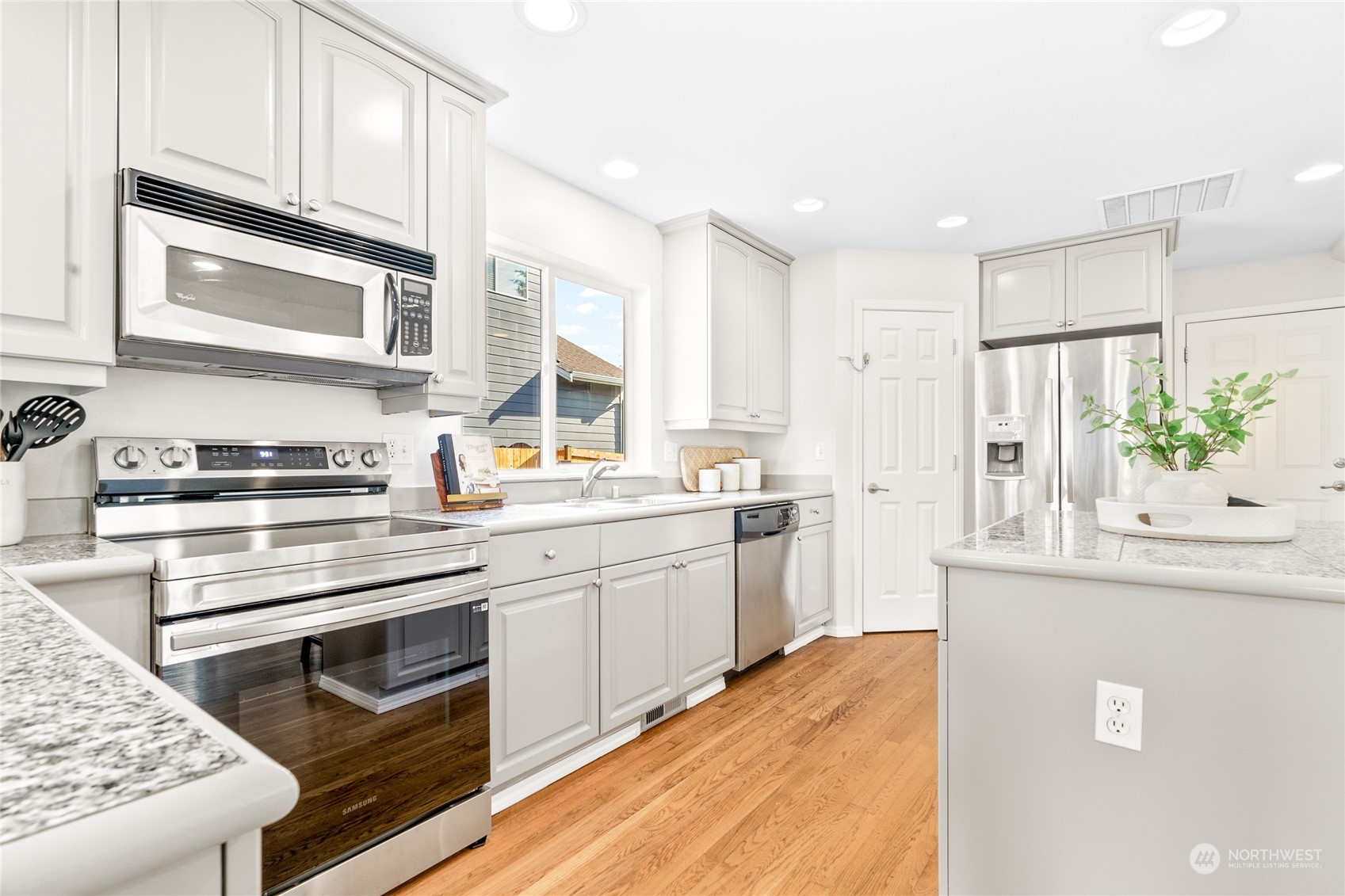 1730 Southeast 30th Place Renton, WA 98055 - Photo 10 of 31 a kitchen with stainless steel appliances white cabinets and a stove top oven