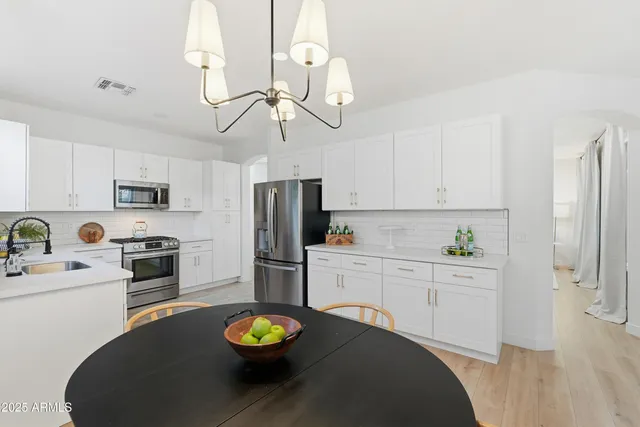 a kitchen with a sink stove top oven and cabinets
