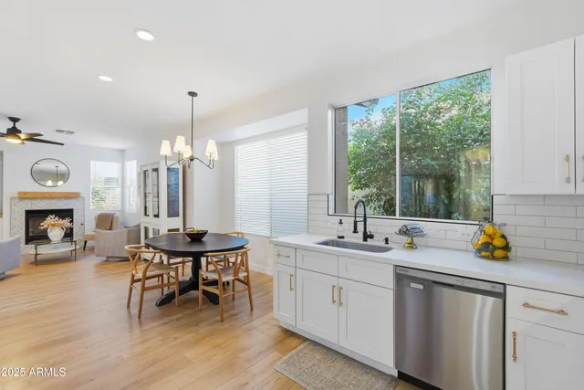 a kitchen with a refrigerator cabinets and wooden floor