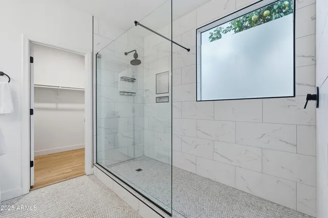 a bathroom with a shower and a glass door