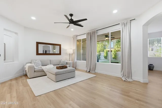 a living room with furniture and a wooden floor