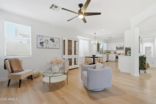 a living room with furniture a fireplace and a large window