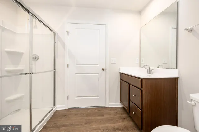 a bathroom with a toilet a sink and mirror