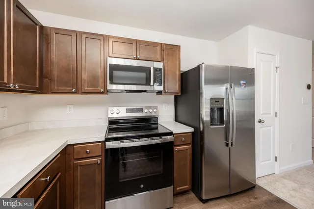 a kitchen with a refrigerator stove and microwave