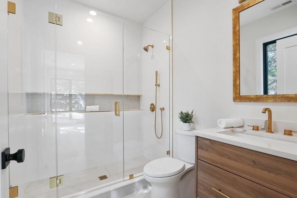 216 Greendale Avenue Needham, MA 02494 - Photo 32 of 40 a bathroom with a granite countertop sink a toilet and shower