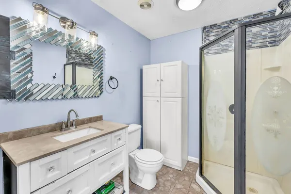 a bathroom with a toilet sink and shower