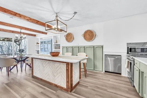 a kitchen with a wooden floor and white appliances