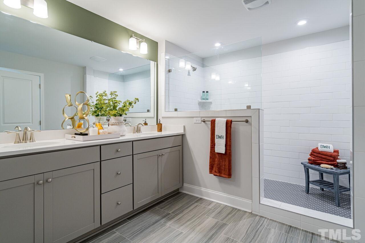 3107 Dunnock Drive, Unit 6 Durham, NC 27713 - Photo 18 of 27 a bathroom with a double vanity sink and a mirror