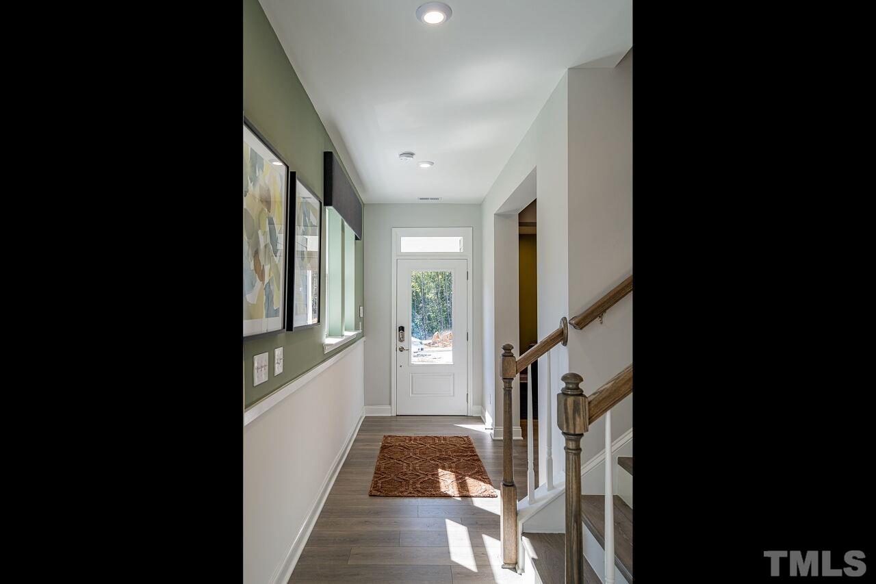 3107 Dunnock Drive, Unit 6 Durham, NC 27713 - Photo 2 of 27 a hallway with a dining table and chairs